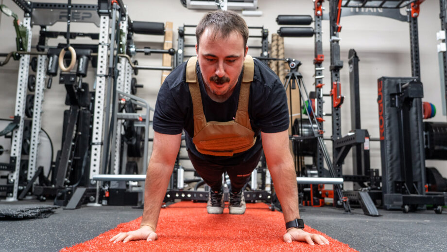 Coop performing pushups in a weighted vest