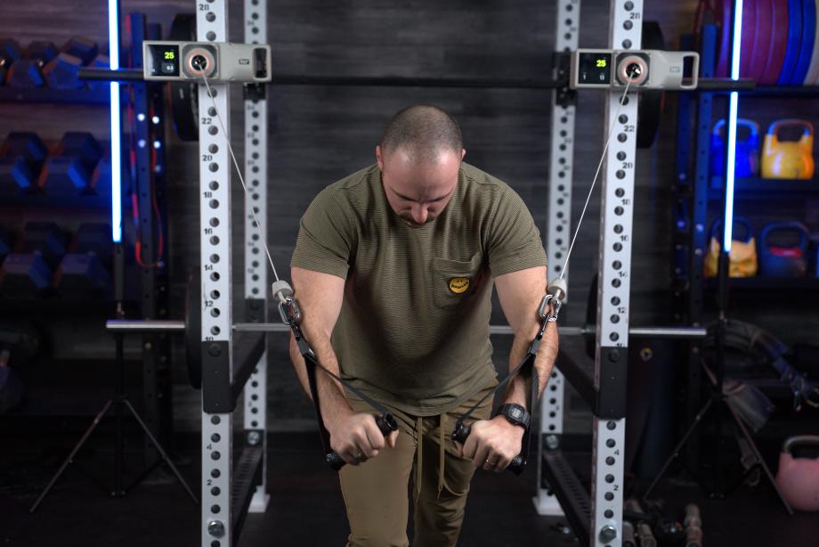 A man works out with the Beyond Power Voltra I.