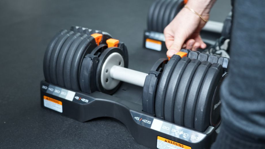 Man adjusting the NordicTrack Dumbbell selectors