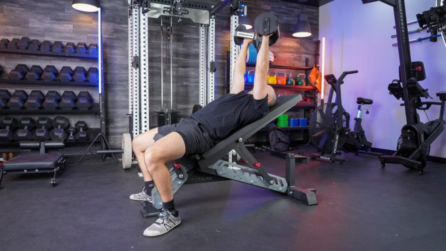Man performing a dumbbell incline bench press on the TITAN Series Adjustable Bench