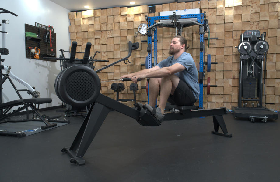 A man working out on the YOSUDA Dragon Fly Rowing Machine